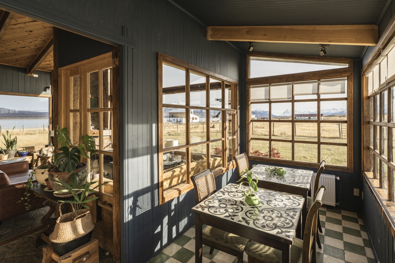 Breakfast room with wood-framed windows looking onto the fjord and steppe