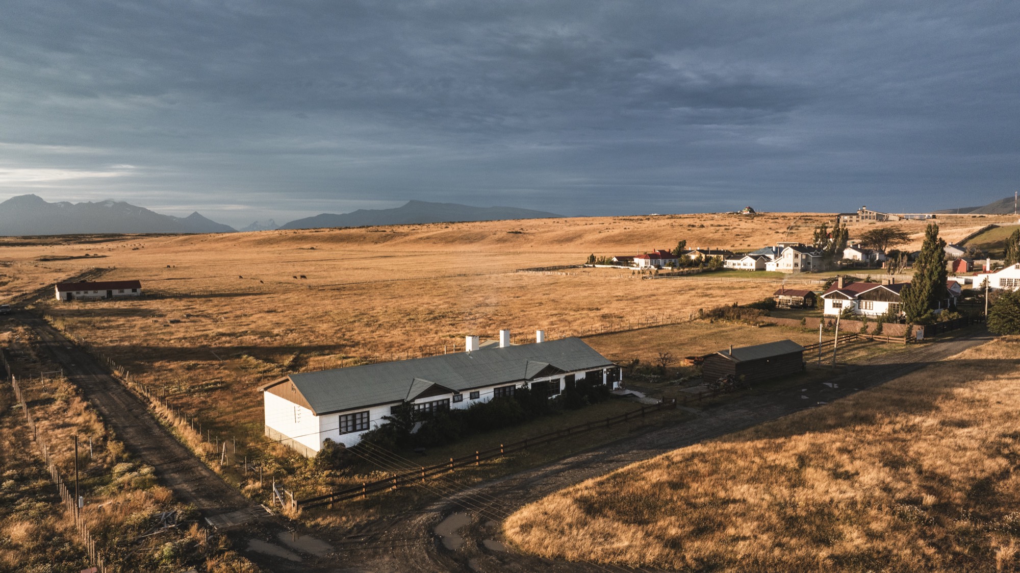 The heritage house in the Patagonian steppe at golden hour, by the Última Esperanza fjord