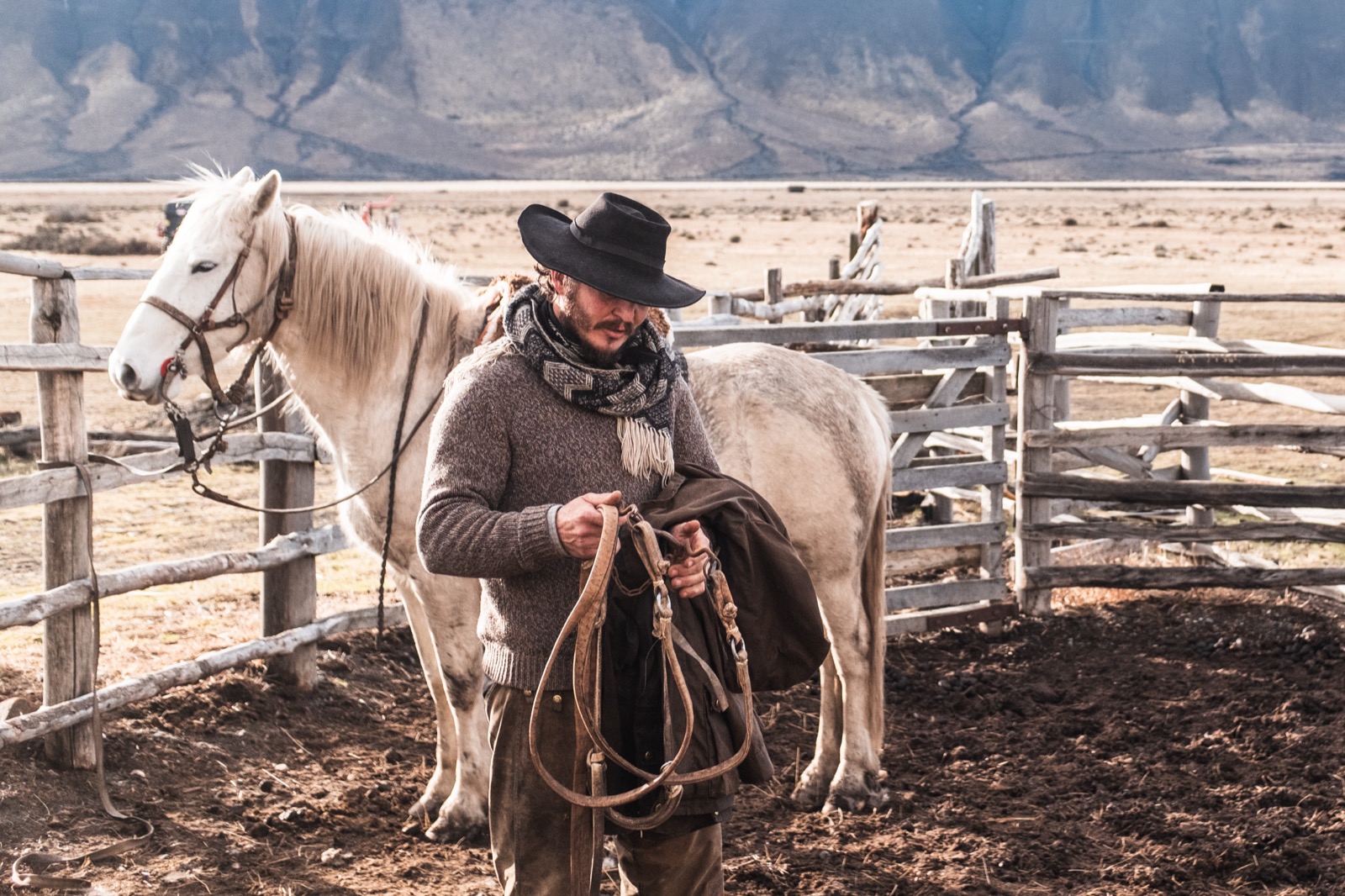 A gaucho with his white horse at the estancia corral