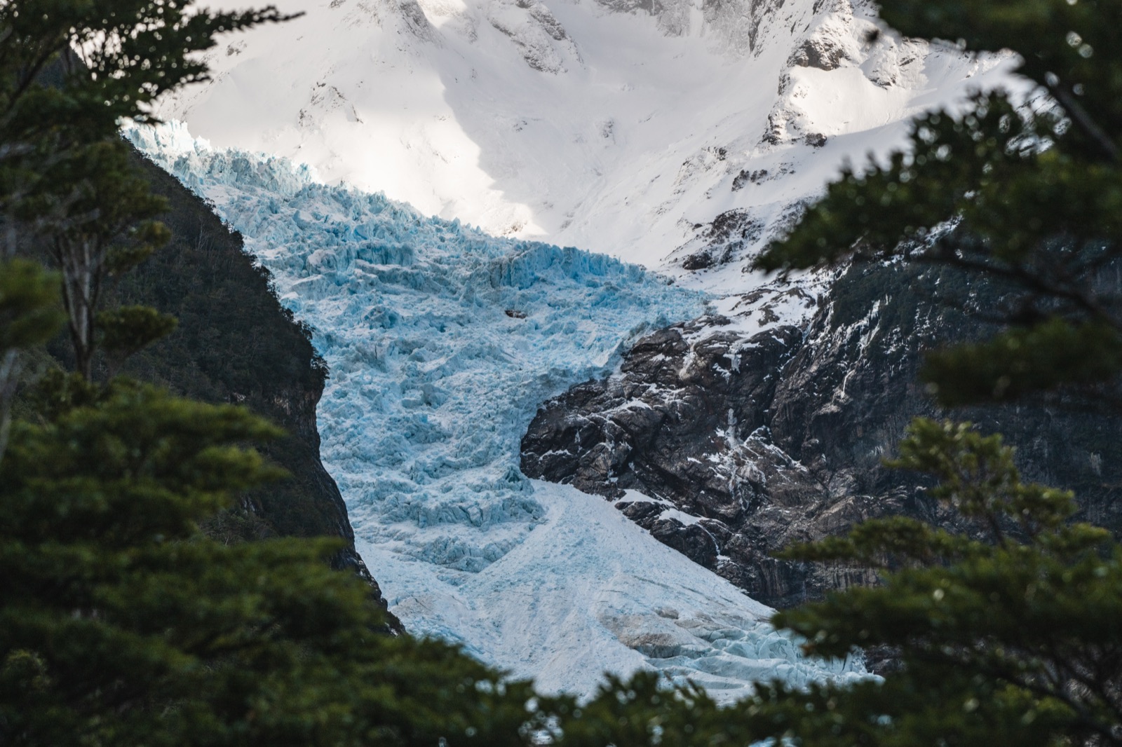 The Balmaceda hanging glacier descending to the Última Esperanza fjord with floating ice